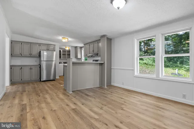 a view of a kitchen with a sink dishwasher and a refrigerator