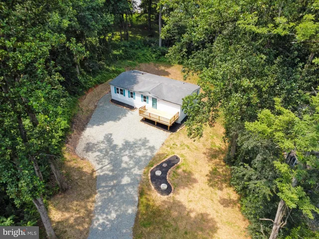 an aerial view of a house with yard swimming pool and outdoor seating