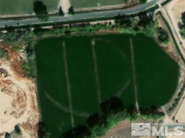 a backyard of a house with a yard and outdoor seating