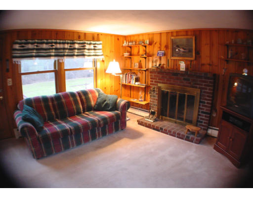 91 Birch Meadow Road Merrimac, MA 01860 - Photo 5 of 9 a living room with furniture a fireplace and a flat screen tv