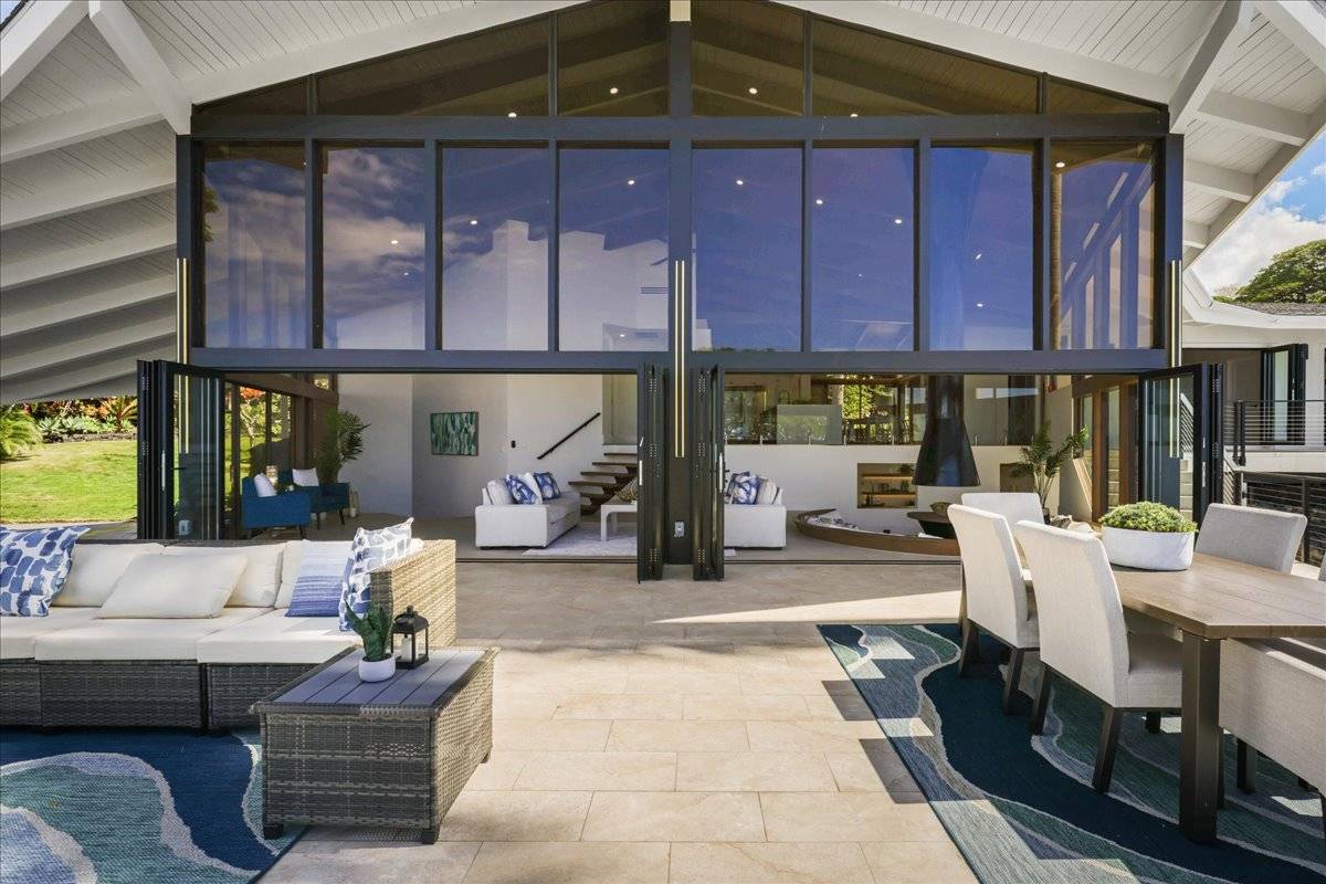 77-404 Pelenike Drive Kailua-Kona, HI 96740 - Photo 13 of 27 a view of a patio with a table and chairs and potted plants