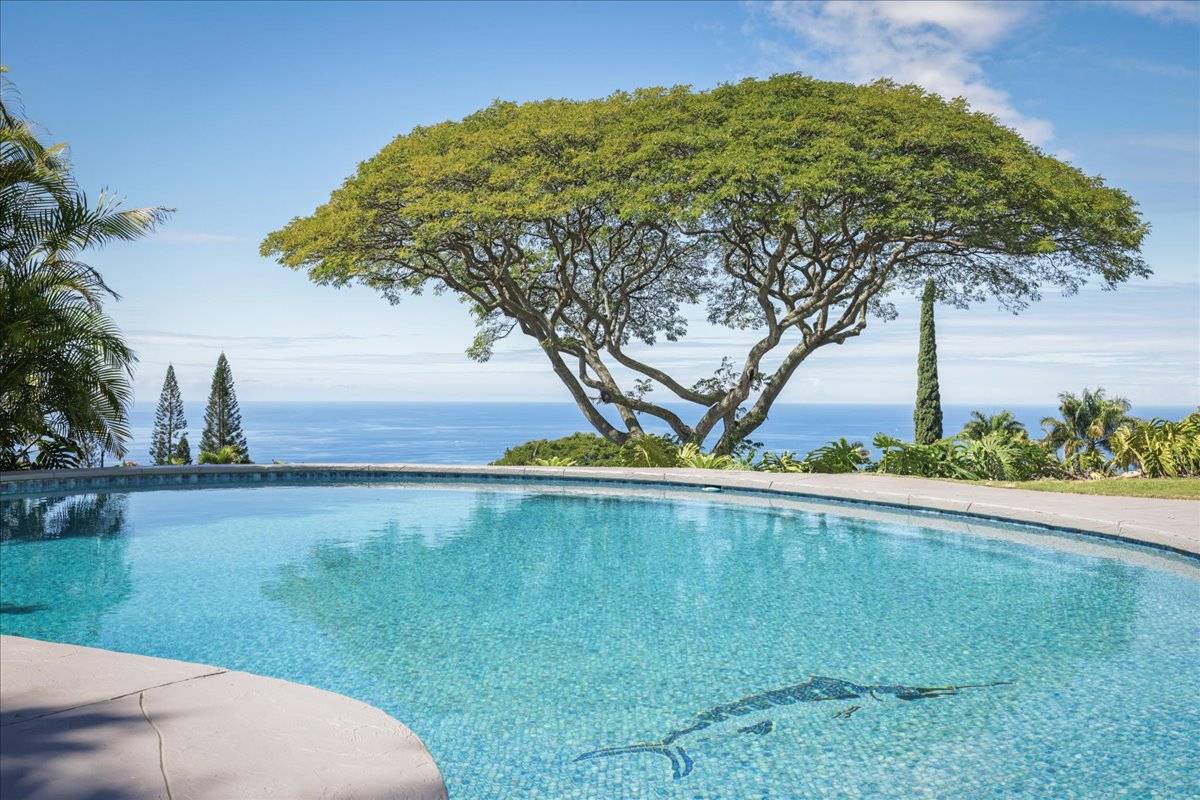 77-404 Pelenike Drive Kailua-Kona, HI 96740 - Photo 21 of 27 a view of a garden with a bench