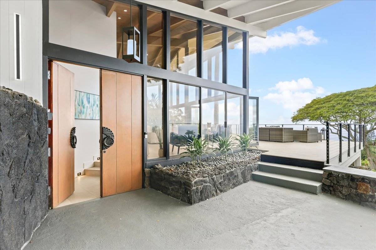 77-404 Pelenike Drive Kailua-Kona, HI 96740 - Photo 4 of 27 a spacious bedroom with a large window and a bed