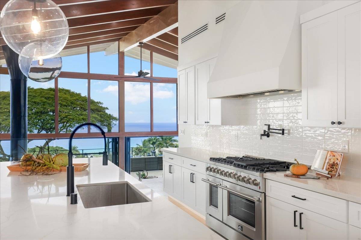 77-404 Pelenike Drive Kailua-Kona, HI 96740 - Photo 10 of 27 a kitchen with appliances cabinets and a large window