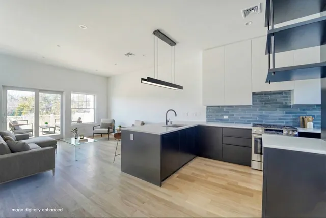 a kitchen with granite countertop a stove a sink dishwasher and a refrigerator with wooden floor