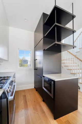 a kitchen with stainless steel appliances a stove and a refrigerator