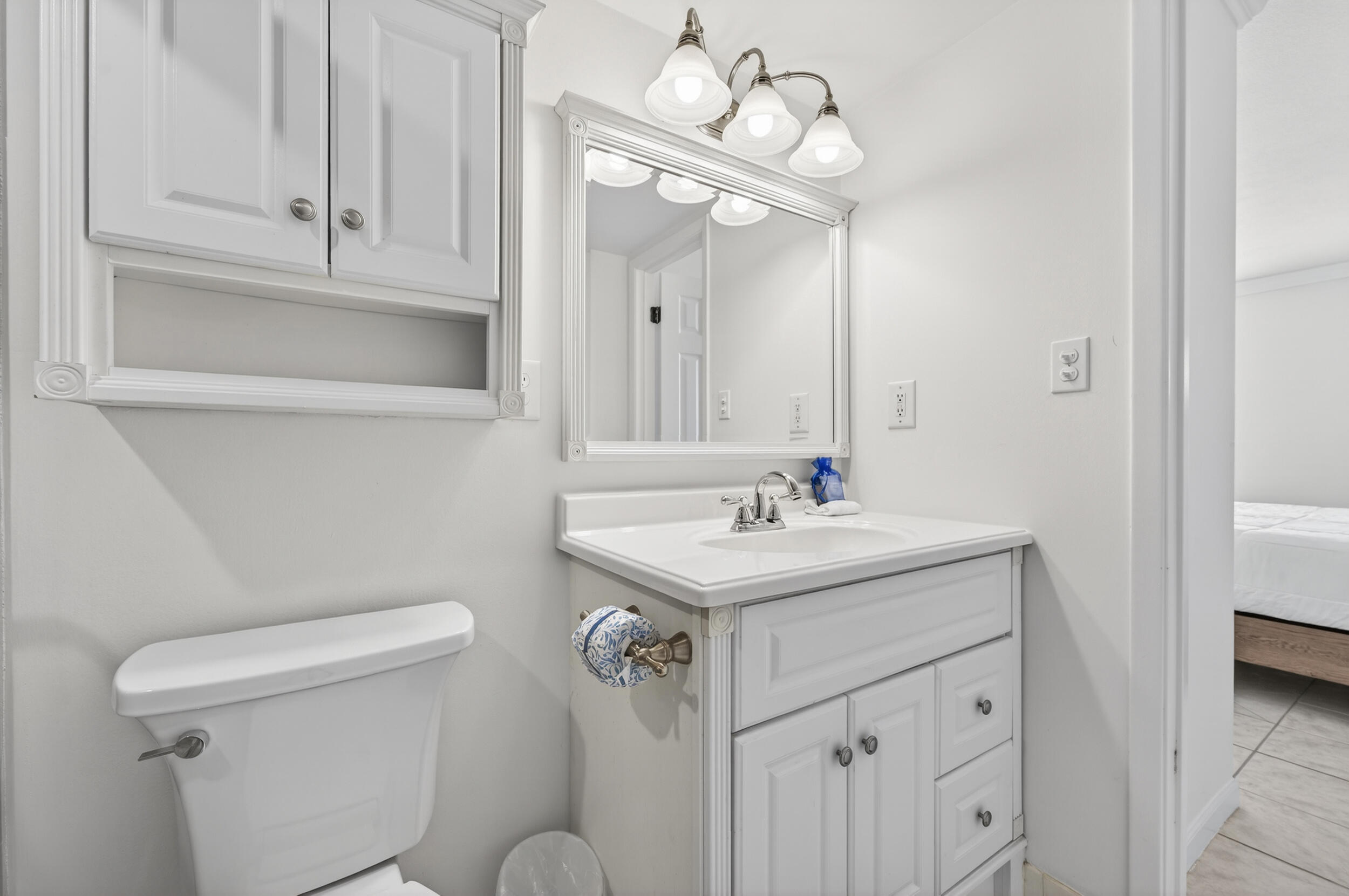 30 Moreno Point Road, Unit 502A Destin, FL 32541 - Photo 31 of 71 a bathroom with a sink a toilet and mirror