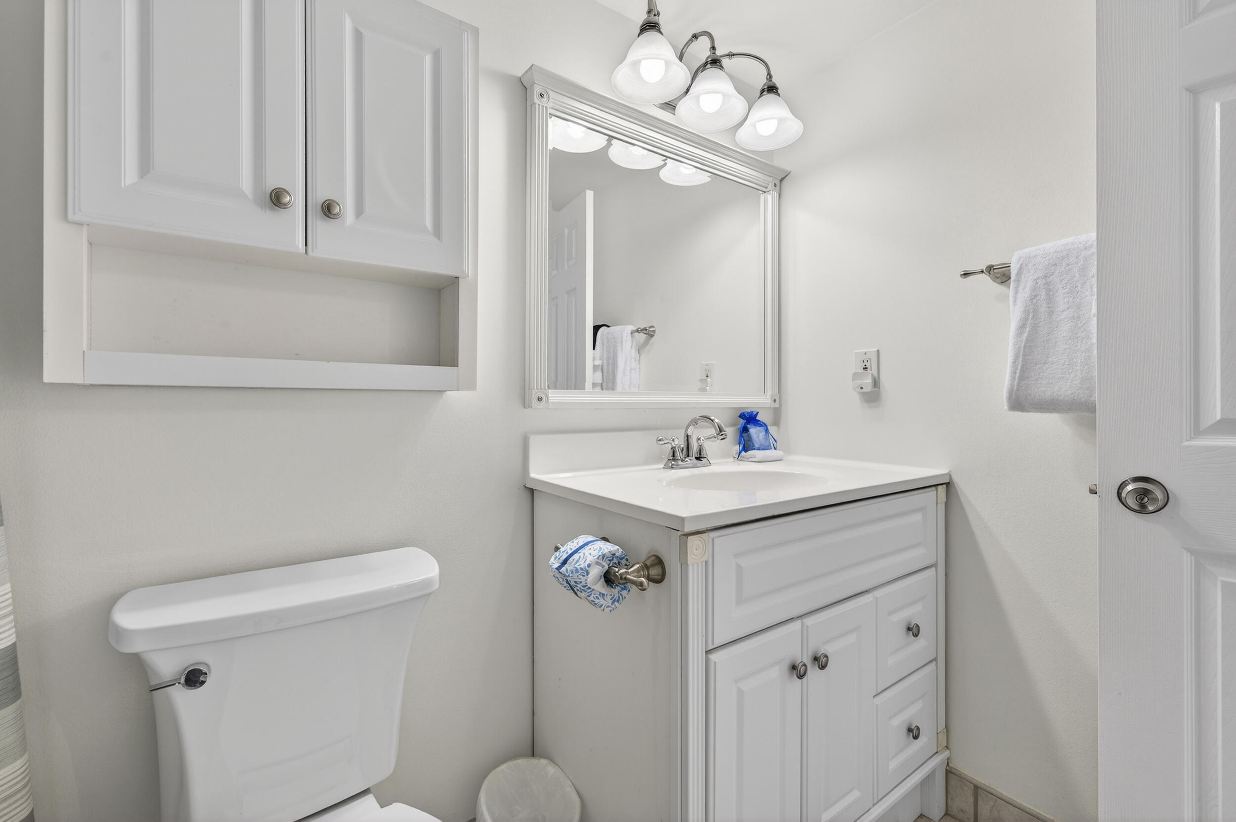 30 Moreno Point Road, Unit 502A Destin, FL 32541 - Photo 44 of 71 a bathroom with a sink a toilet and mirror