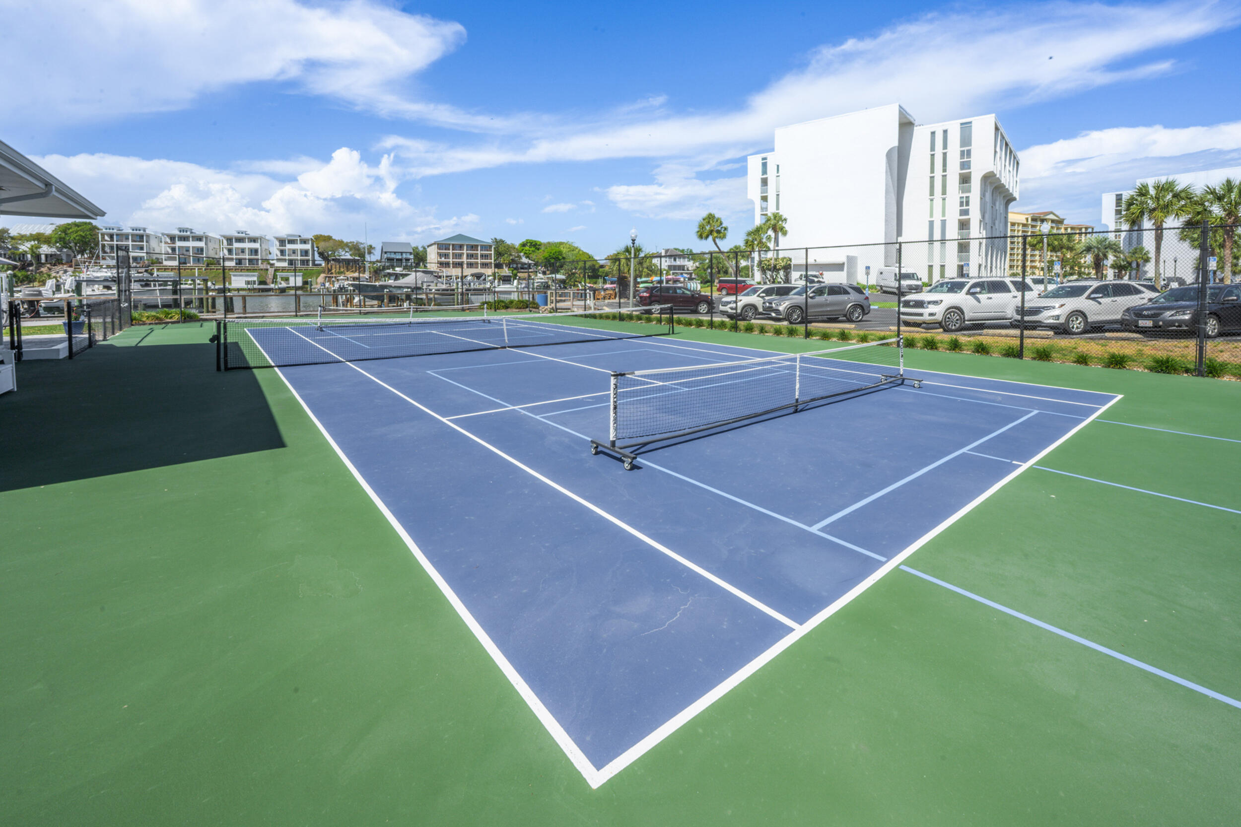 30 Moreno Point Road, Unit 502A Destin, FL 32541 - Photo 71 of 71 a tennis court with view of buildings in the background