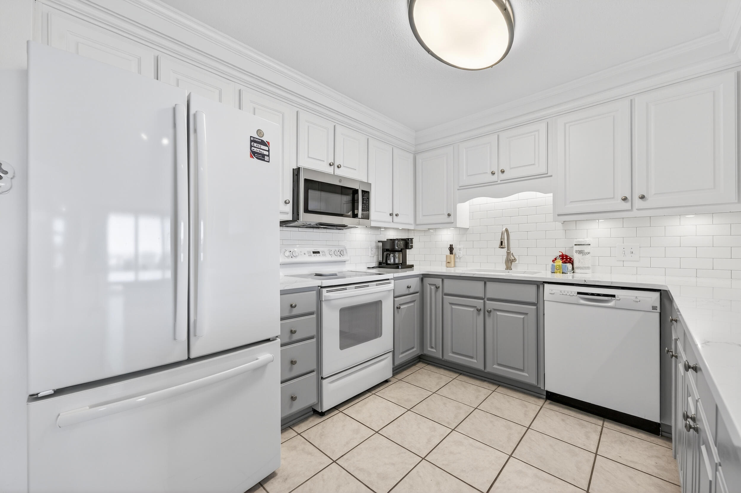 30 Moreno Point Road, Unit 502A Destin, FL 32541 - Photo 10 of 71 a kitchen with cabinets stainless steel appliances and a sink