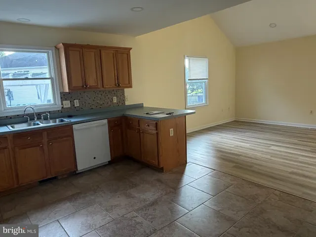 a kitchen with stainless steel appliances granite countertop a sink and cabinets