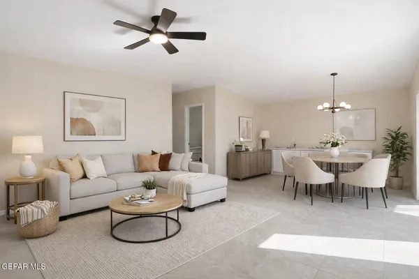 a living room with furniture a rug and a chandelier