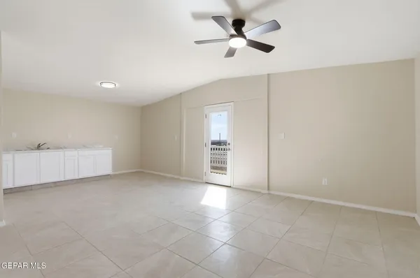 a view of a big room with closet and a ceiling fan