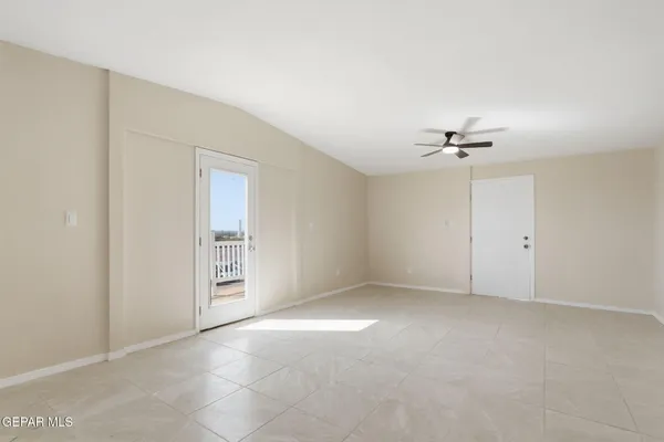 a view of an empty room with a fan