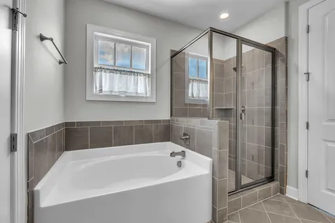 a bathroom with a bathtub and a shower