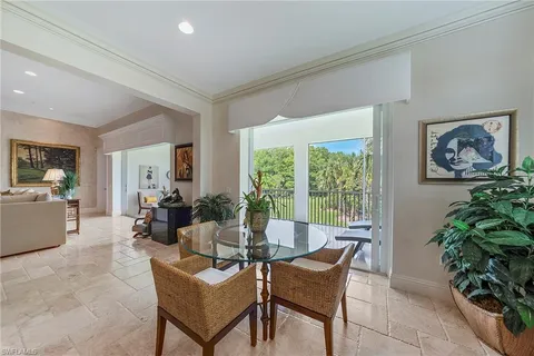 a living room with furniture kitchen view and a chandelier