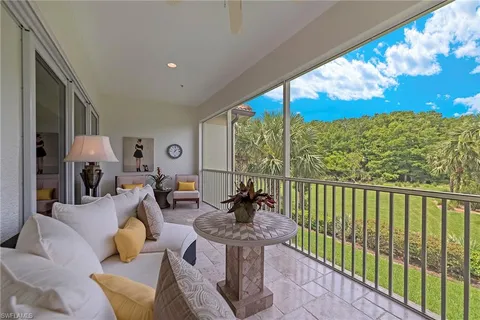 a dining room with furniture and a potted plant