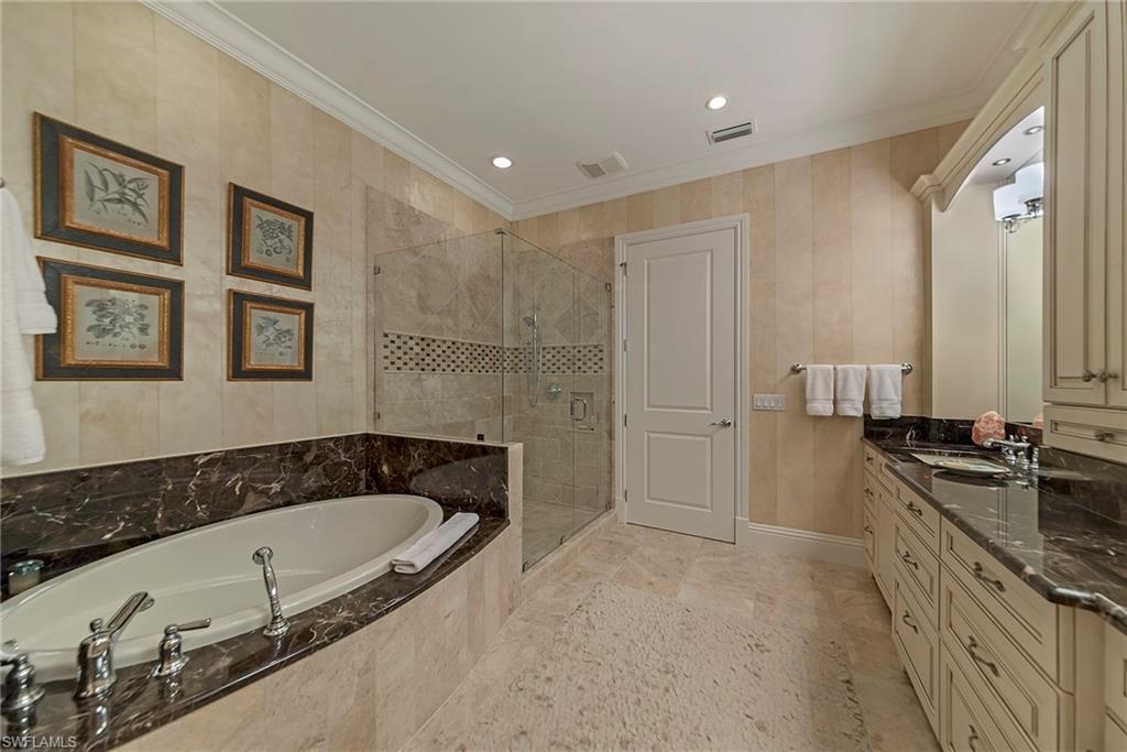 12014 Covent Garden Court, Unit 202 Naples, FL 34120 - Photo 26 of 50 Full bathroom featuring crown molding, a shower stall, double vanity, a garden tub, and recessed lighting
