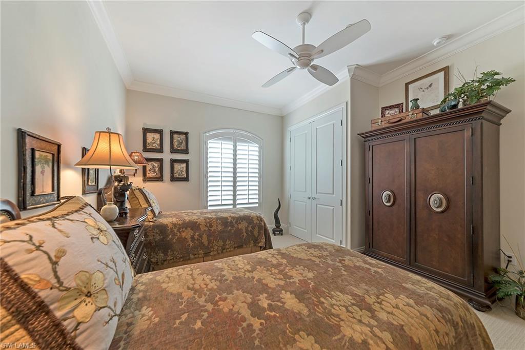 12014 Covent Garden Court, Unit 202 Naples, FL 34120 - Photo 28 of 50 Bedroom with light carpet, crown molding, a closet, and a ceiling fan