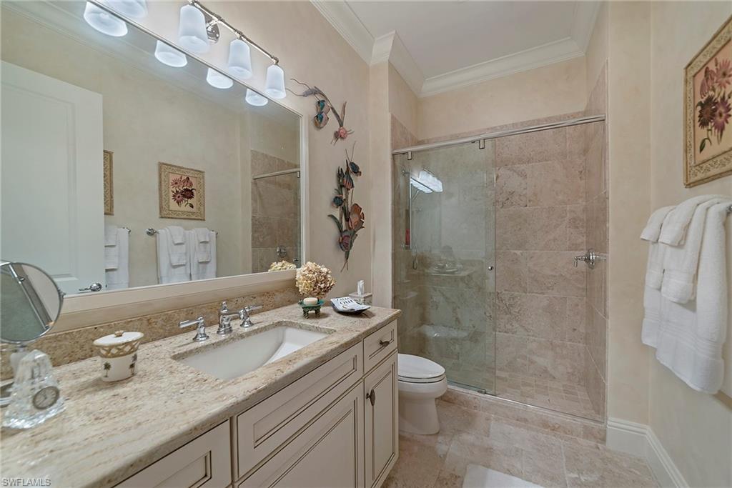 12014 Covent Garden Court, Unit 202 Naples, FL 34120 - Photo 30 of 50 Full bathroom featuring ornamental molding, vanity, and a shower stall