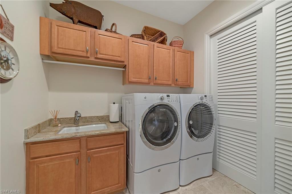 12014 Covent Garden Court, Unit 202 Naples, FL 34120 - Photo 31 of 50 Laundry area with cabinet space and separate washer and dryer
