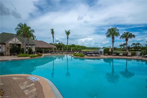a view of swimming pool with outdoor seating and plants
