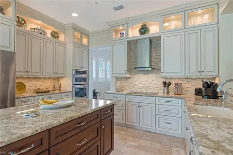 a kitchen that has a lot of cabinets in it and appliances