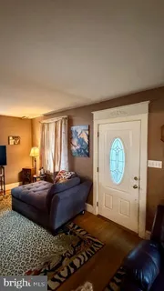a living room with a bed furniture and a window