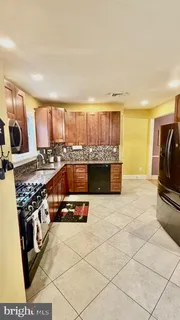 a kitchen with a stove a sink and a refrigerator