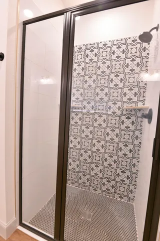 a bathroom with a shower and a window