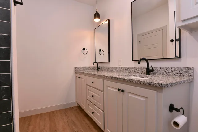 a utility room with wooden floor washer and dryer