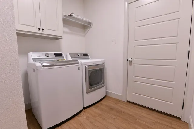 a view of white cabinets and wooden floor