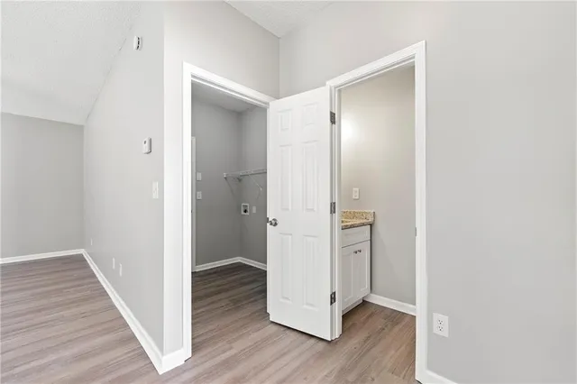 a view of hallway with wooden floor
