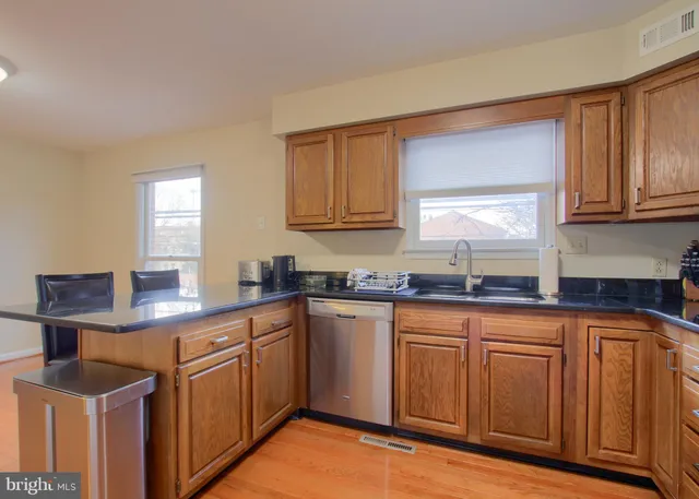 a kitchen with stainless steel appliances granite countertop a sink and cabinets