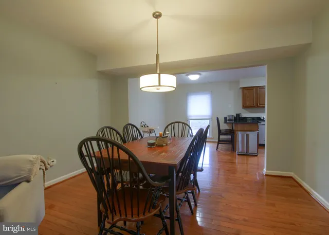 a view of a dining room with furniture and chandelier