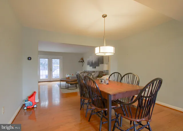 a view of a dining room with furniture and a chandelier