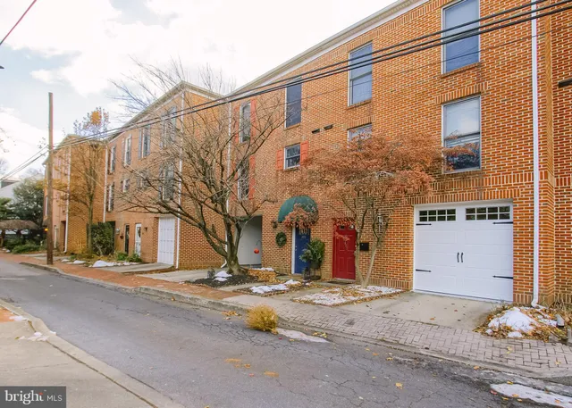a view of a building with snow on the road