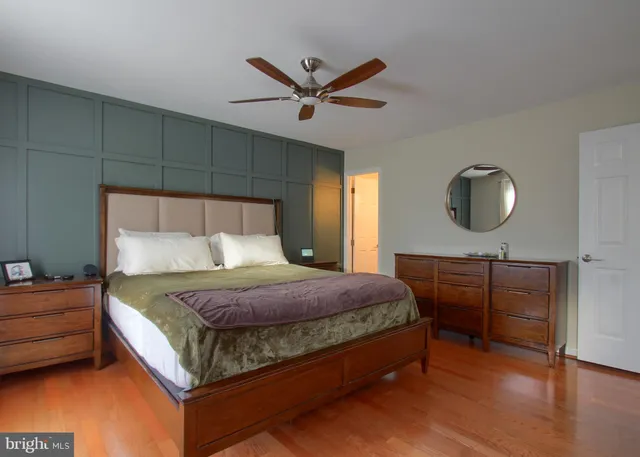 a bedroom with a bed and a ceiling fan