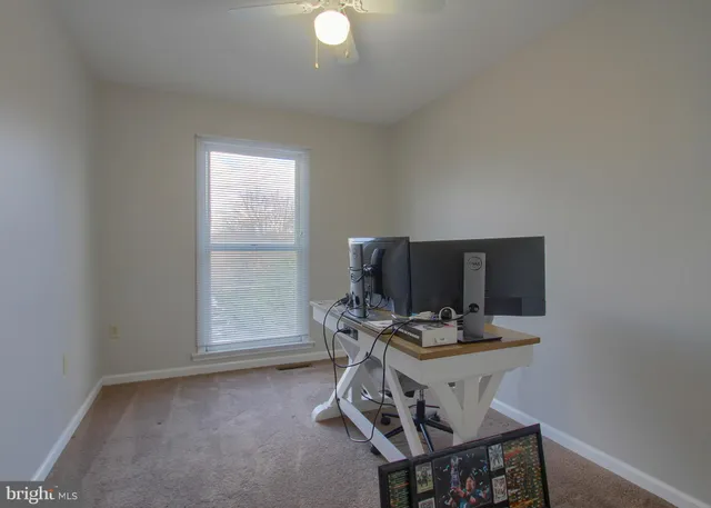a bathroom with a granite countertop toilet a sink and a mirror