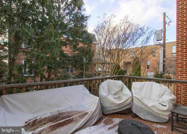 a view of a chairs and table in the back yard