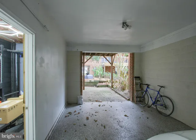 a view of a hallway with wooden floor and a fireplace