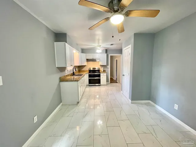 a view of a kitchen with a sink and a window