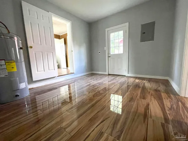 wooden floor in an empty room with a window