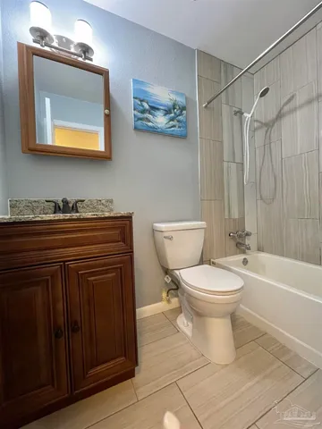 a bathroom with a toilet a sink and bathtub