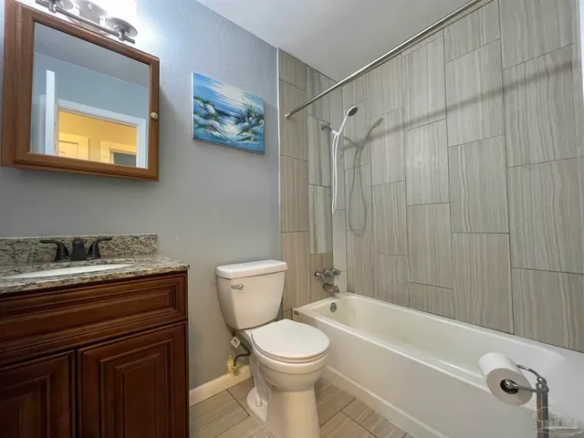 a bathroom with a toilet a sink and bathtub