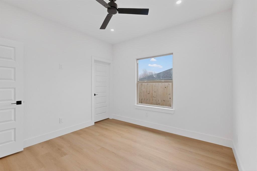 10110 Budtime Lane Dallas, TX 75217 - Photo 24 of 34 an empty room with a window and a ceiling fan