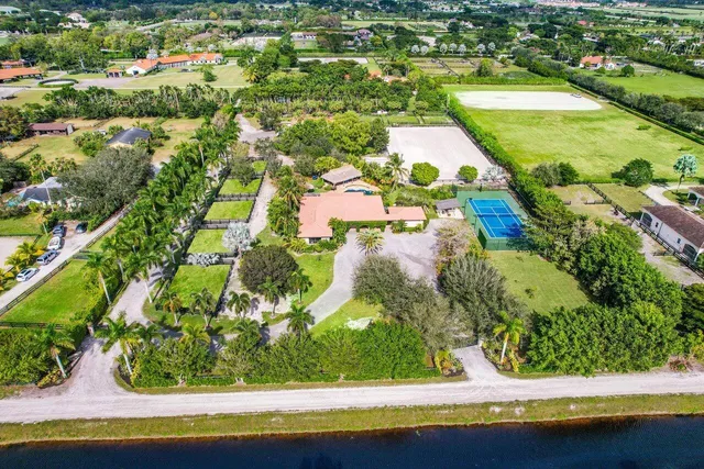 an aerial view of residential houses with outdoor space and swimming pool