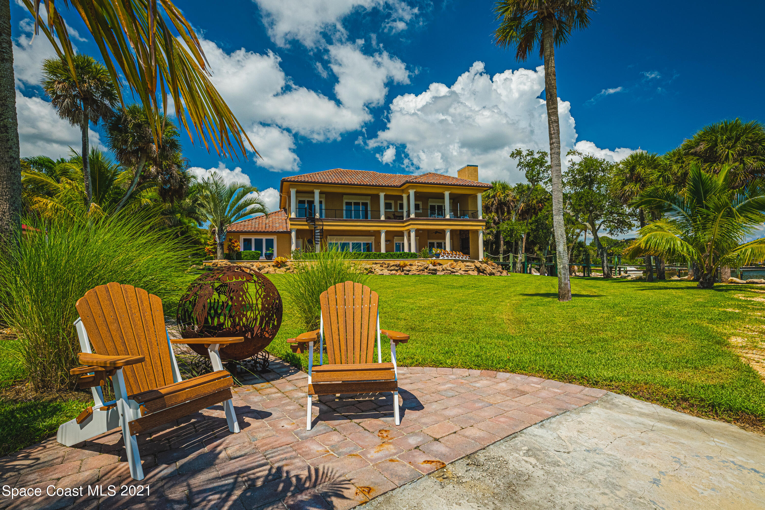 5419 Robles Lane Rockledge, FL 32955 - Photo 49 of 61 a view of a swimming pool and lounge chairs in the patio