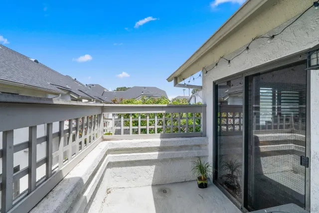 a porch with a table and chairs