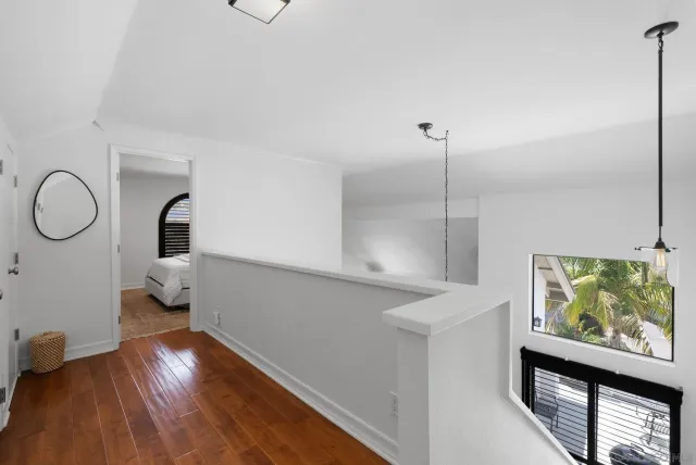 a bedroom with bed and a potted plant